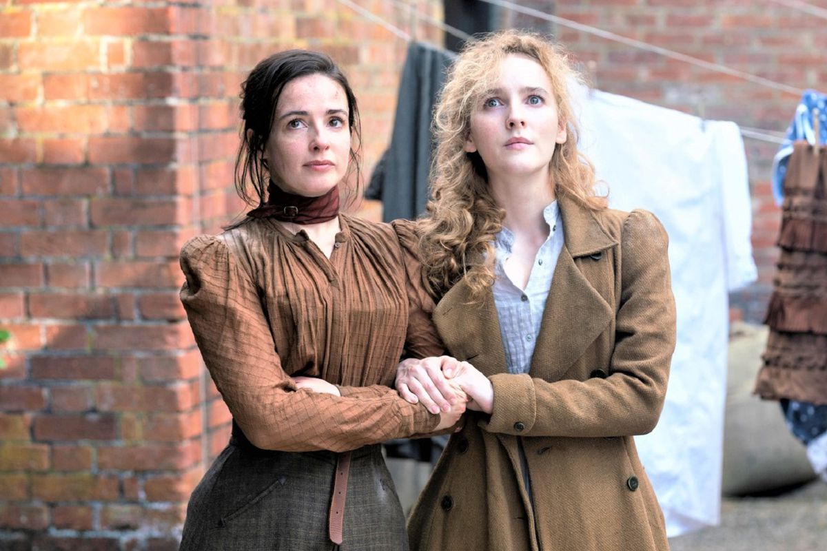 Amalia (Laura Donnelly) and Penance (Ann Skelly), two Victorian-era women in matching brown dresses, stand side by side in The Nevers