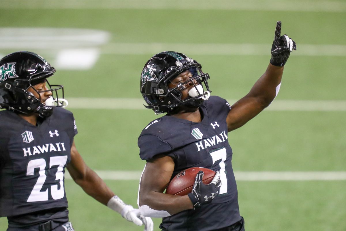 Calvin Turner of the Hawaii Rainbow Warriors gestures as he crosses the goal line to score a touchdown during the fourth quarter against the New Mexico Lobos at Aloha Stadium on November 7, 2020 in Honolulu, Hawaii.
