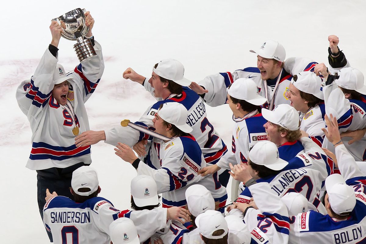 Cam York #4 of the United States hoists the World Junior Championship trophy after beating Canada during the 2021 IIHF World Junior Championship gold medal game at Rogers Place on January 5, 2021 in Edmonton, Canada.
