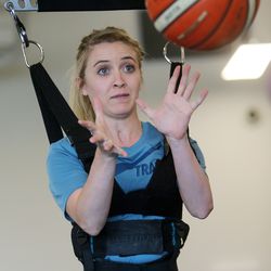 Kendal Levine, who was hit by a car while on a mission in Australia, tries to catch a basketball as she works with physical therapist Marissa Moran at Neuroworx in Sandy on Thursday, April 25, 2019.
