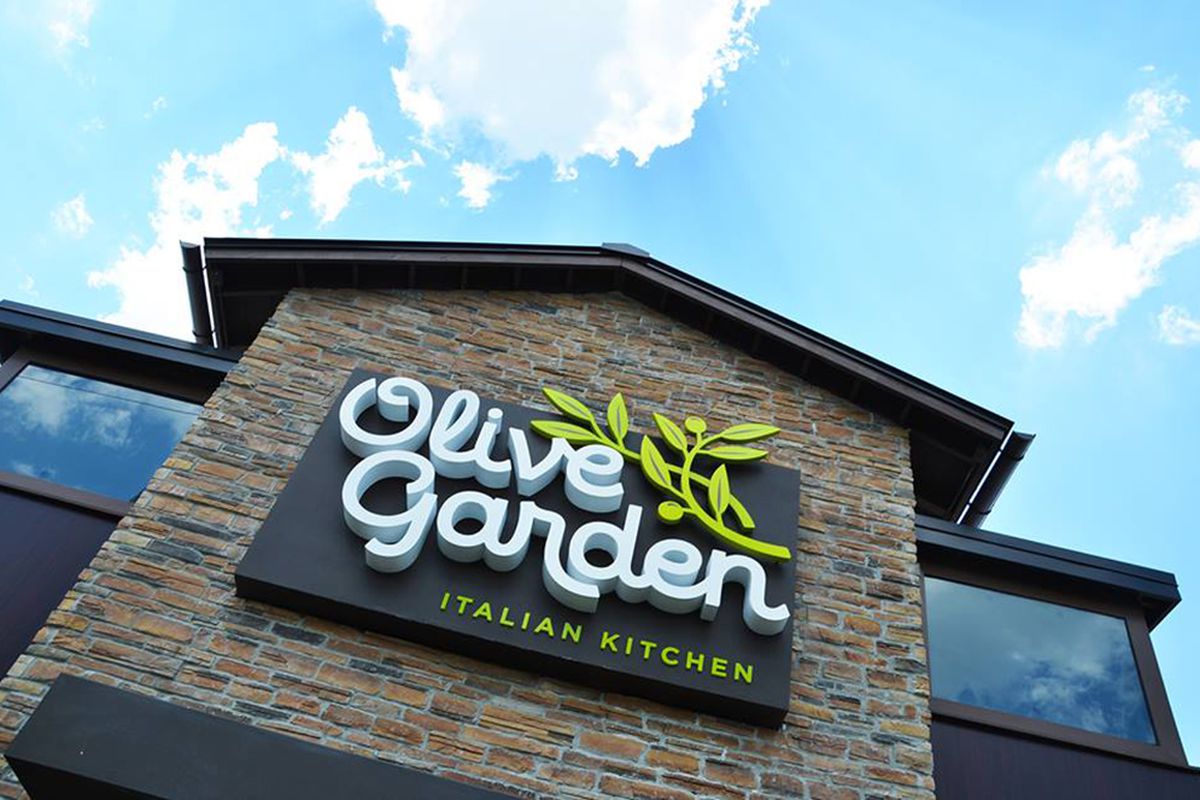 The exterior of a faux-stone building with an Olive Garden sign