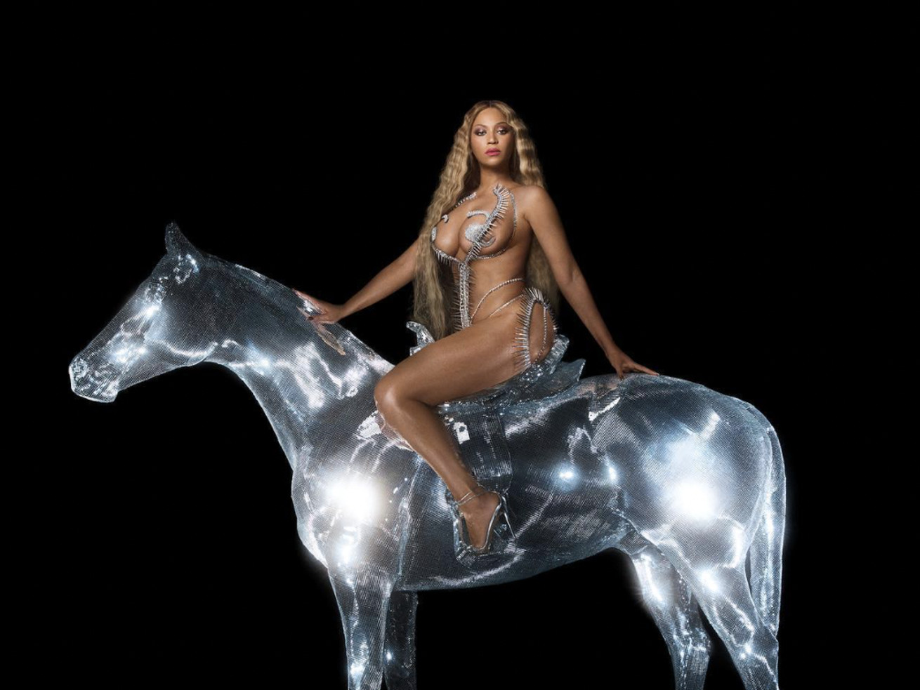 Beyoncé sitting astride a horse that appears to be made of light.