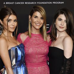 FILE - In this Feb. 28, 2019 file photo, actress Lori Loughlin, center, poses with daughters Olivia Jade Giannulli, left, and Isabella Rose Giannulli at the 2019 "An Unforgettable Evening" in Beverly Hills, Calif. Loughlin and her husband Mossimo Giannulli were charged along with nearly 50 other people Tuesday in a scheme in which wealthy parents bribed college coaches and other insiders to get their children into some of the most elite schools in the country, federal prosecutors said. (Photo by Chris Pizzello/Invision/AP, File)