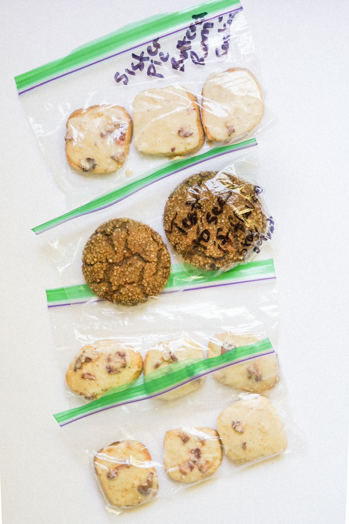 Two different kinds of cookies, placed in groups of 2 or 3 in small zip-top plastic bags.