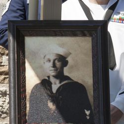 A United States Navy sailor stands next to a photograph of machinist’s mate Petty Officer 1st Class Vernon Luke of Green Bay, Wis., a sailor killed in the attack on Pearl Harbor, at his funeral service, Wednesday, March 9, 2016 in Honolulu. The 43-year-old was killed when Japanese planes bombed his battleship, the USS Oklahoma on Dec. 7, 1941. After World War II, he was buried as an “unknown” along with nearly 400 other unidentified sailors and Marines from the battleship. 