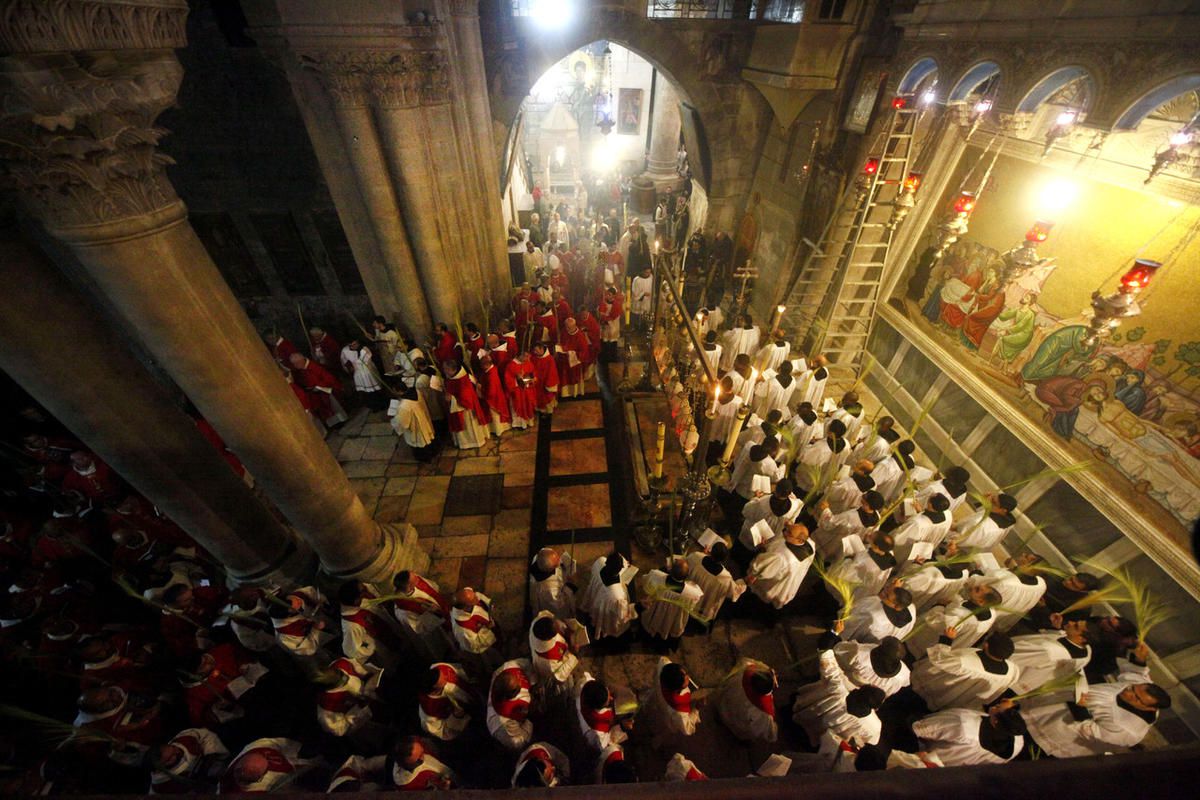 Christian clergymen carry palm fronds during the Palm Sunday procession in the Church of the Holy Sepulcher, traditionally believed by many to be the site of the crucifixion, in Jerusalem's Old City,  Sunday, March 20, 2016.  (AP Photo/Mahmoud Illean)