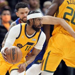 Utah Jazz guard Mike Conley, front, drives past Denver Nuggets’ guard Austin Rivers in the first half of an NBA basketball game Wednesday, Jan. 5, 2022, in Denver. 