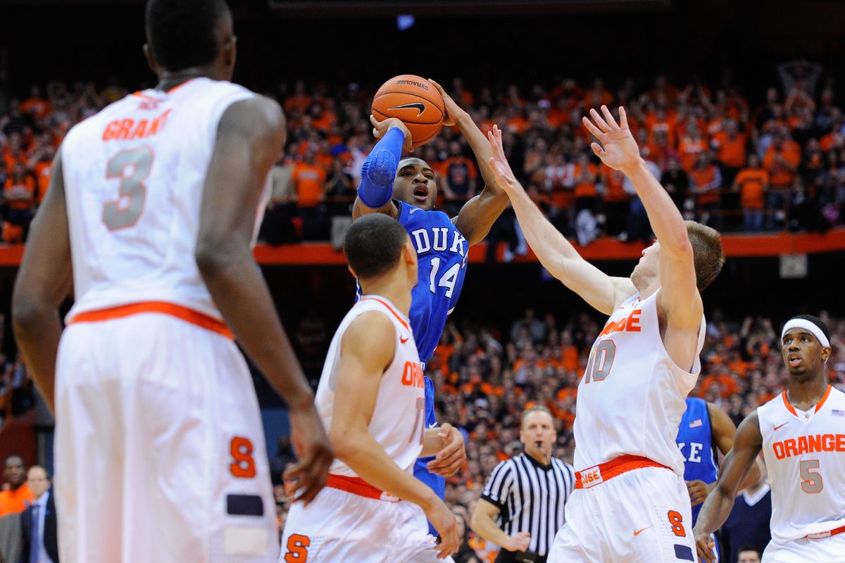  Rasheed Sulaimon #14 of the Duke Blue Devils takes a shot over Trevor Cooney #10 of the Syracuse Orange during the second half at the Carrier Dome on February 1, 2014 in Syracuse, New York. Syracuse defeated Duke 91-89 in overtime.