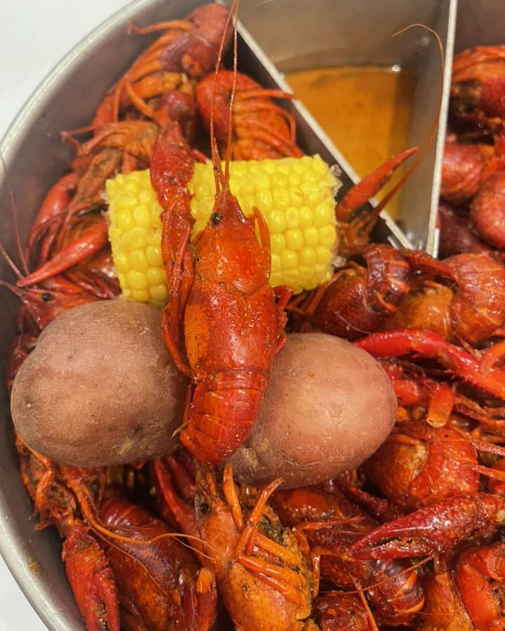 Image of a crawfish bowl with potatoes and corn.