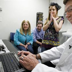 Eighteen-year-old Tayler Hansen, along with her parents Sharen and Mark Hansen, sees her  progress on X-rays with orthopedic surgeon Dr. John Smith at Primary Children's Medical Center.  