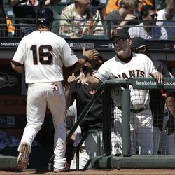 San Francisco Giants' Angel Pagan (16) is congratulated by manager Bruce Bochy, right, after scoring during the second inning of a baseball game against the Colorado Rockies in San Francisco, Wednesday, April 10, 2013. 