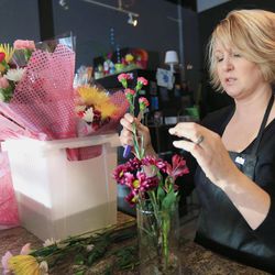 Rhonda Bullington, owner of Loess Hills Floral Studio in Council Bluffs, Iowa, makes a flower arrangement in Council Bluffs, Iowa, Friday, Feb. 6, 2015. The vast majority of cut flowers used in florists' bouquets are imported and Bullington says she hasn't had any customers asking for locally-grown flowers.  