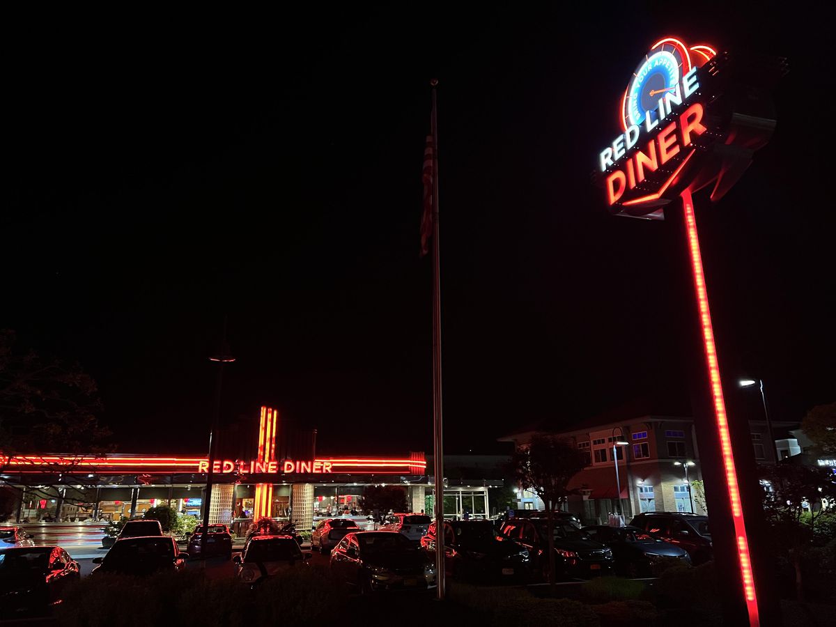 A nighttime view of Red Line Diner’s lit-up sign.