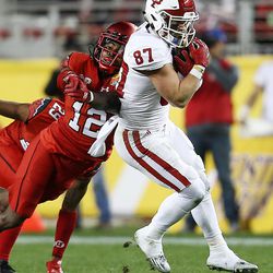 Utah Utes defensive back Justin Thomas (12) misses as he tries to knock the ball away from Indiana Hoosiers wide receiver Mitchell Paige (87) as the Utes and the Hoosiers play in the Foster Farms Bowl in Santa Clara, California on Wednesday, Dec. 28, 2016.