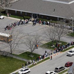Families wait to pick up their students at a church as the Davis County Bomb Squad investigates a suspicious package at Mountain View Elementary School in Layton Monday, April 22, 2013.
