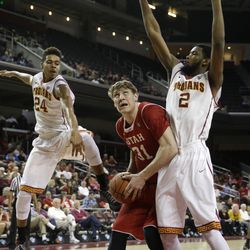 Utah's Dallin Bachynski, center, looks to shoot as he is defended by Southern California's Malik Marquetti, left, and Malik Martin during the first half of an NCAA college basketball game, Sunday, Feb. 1, 2015, in Los Angeles. (AP Photo/Jae C. Hong)