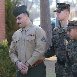 Cpl. Wassef Hassoun is escorted to the courtroom on Camp Lejeune in Jacksonville, N.C., Monday, Feb. 9, 2015, for the beginning of his court martial trial. The U.S. Marine who vanished from his post in Iraq a decade ago and later wound up in Lebanon chose Monday to have his case decided by a military judge instead of a jury. 