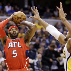 Atlanta Hawks forward Josh Smith (5) shoots over Indiana Pacers forward David West in the first half of Game 2 of a first-round NBA basketball playoff series in Indianapolis, Wednesday, April 24, 2013. 