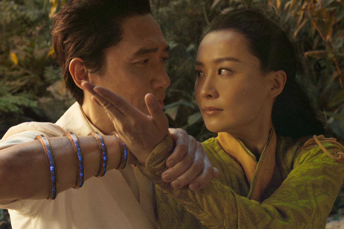 Tony Leung as Wenwu and Fala Chen as Jiang Li in a combative embrace.