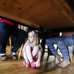 Ashley Johnson waits for her turn while playing a game with her family at their home in Orem on Tuesday, March 29, 2016.