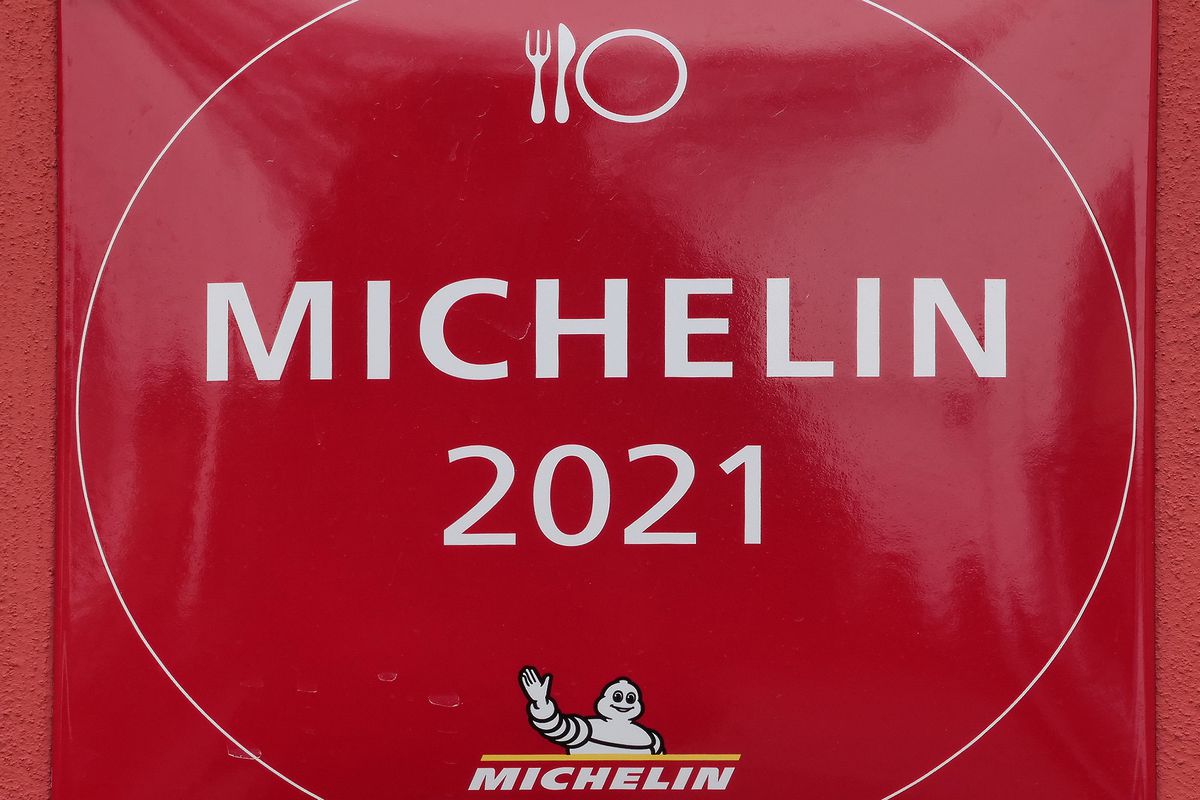 Sign for Michelin Guide 2021 on a red wall.