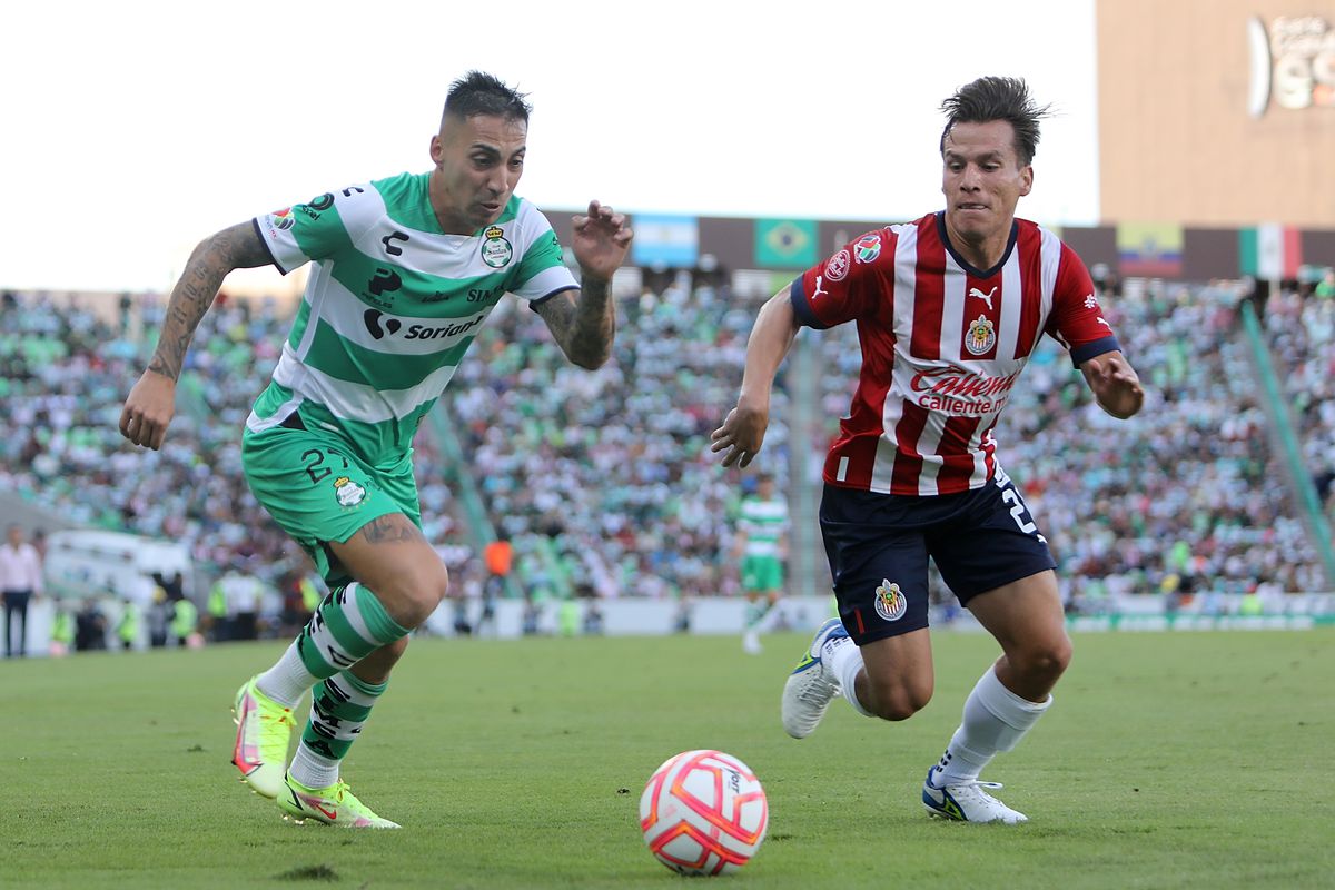 Javier Correa (L) of Santos fights for the ball with Ruben Gonzalez (R) of Chivas during the 3rd round match between Santos Laguna and Chivas as part of the Torneo Apertura 2022 Liga MX at Corona Stadium on July 16, 2022 in Torreon, Mexico.