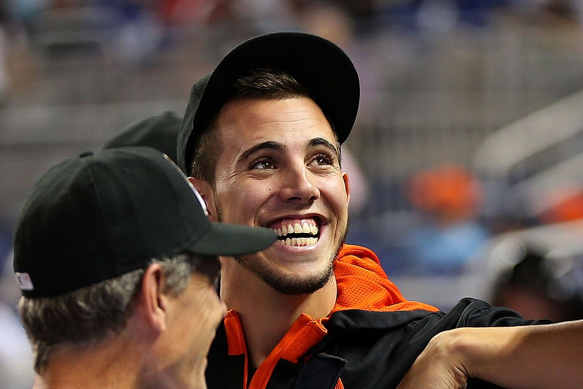 Jose Fernandez #16 of the Miami Marlins looks on from the dugout after undergoing Tommy John surgery during a game against the Philadelphia Phillies at Marlins Park