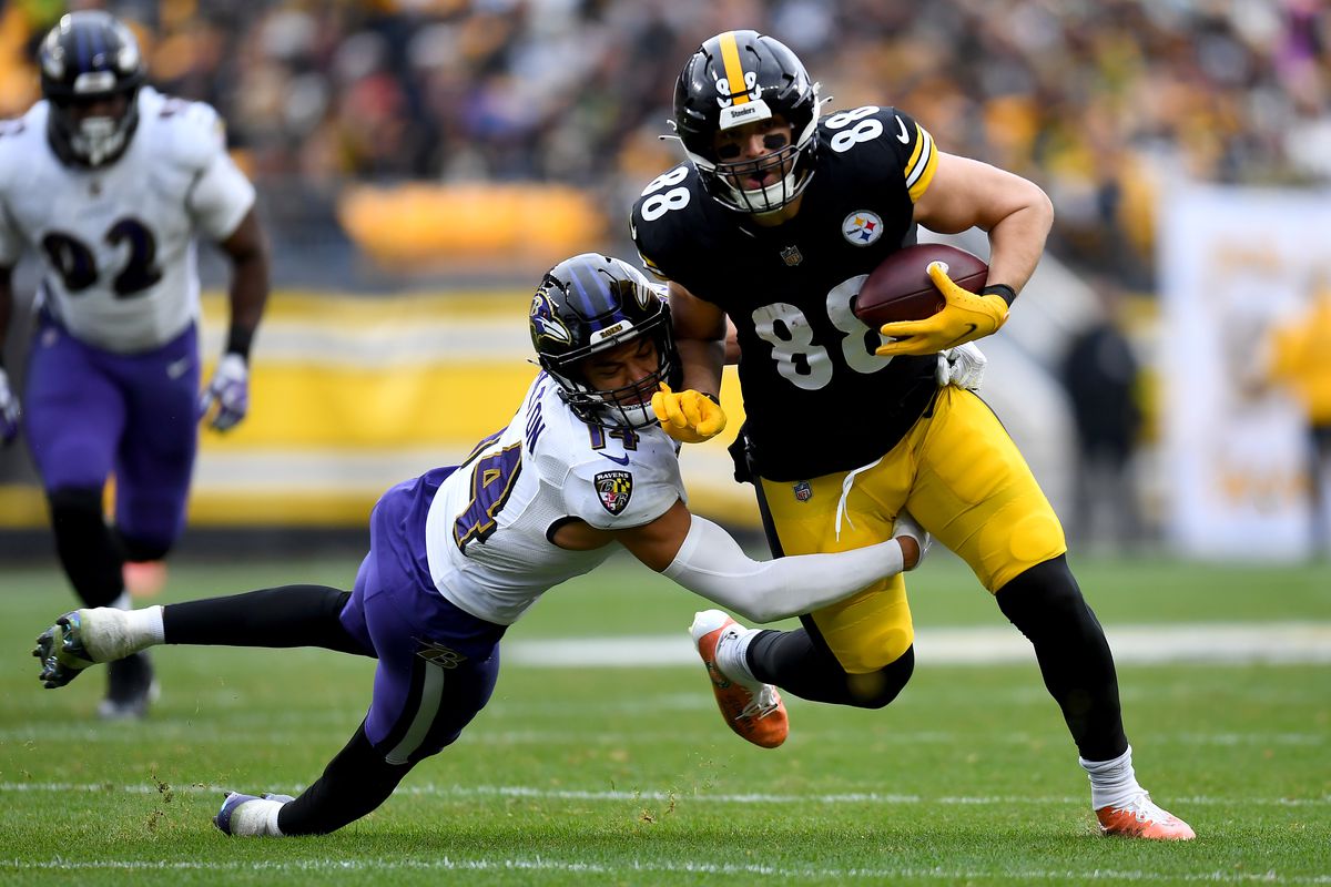 PITTSBURGH, PENNSYLVANIA - DECEMBER 11: Pat Freiermuth #88 of the Pittsburgh Steelers runs with the ball as Kyle Hamilton #14 of the Baltimore Ravens attempts the tackle during the second quarter of the game at Acrisure Stadium on December 11, 2022 in Pittsburgh, Pennsylvania.