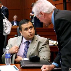 George Zimmerman, left, talks to Seminole County Investigator Robert Hemmert in Seminole circuit court during a pretrial hearing, in Sanford, Fla., Saturday afternoon, June 8, 2013. Zimmerman has been charged with second-degree murder for the 2012 shooting death of Trayvon Martin. 