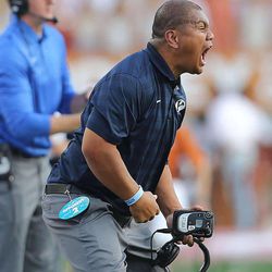 BYU running backs coach Mark Atuaia yells out to his players as BYU and Texas play Saturday, Sept. 6, 2014, in Austin Texas.