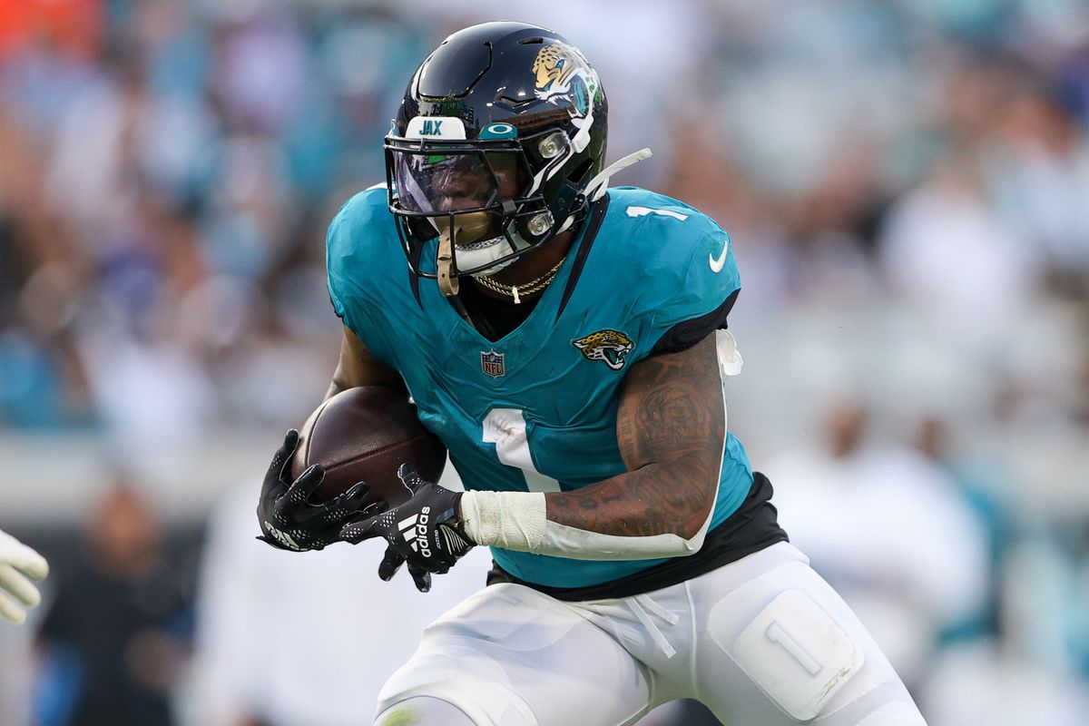 Jacksonville Jaguars running back Travis Etienne Jr. (1) runs with the ball against the Miami Dolphins in the first quarter at EverBank Stadium.