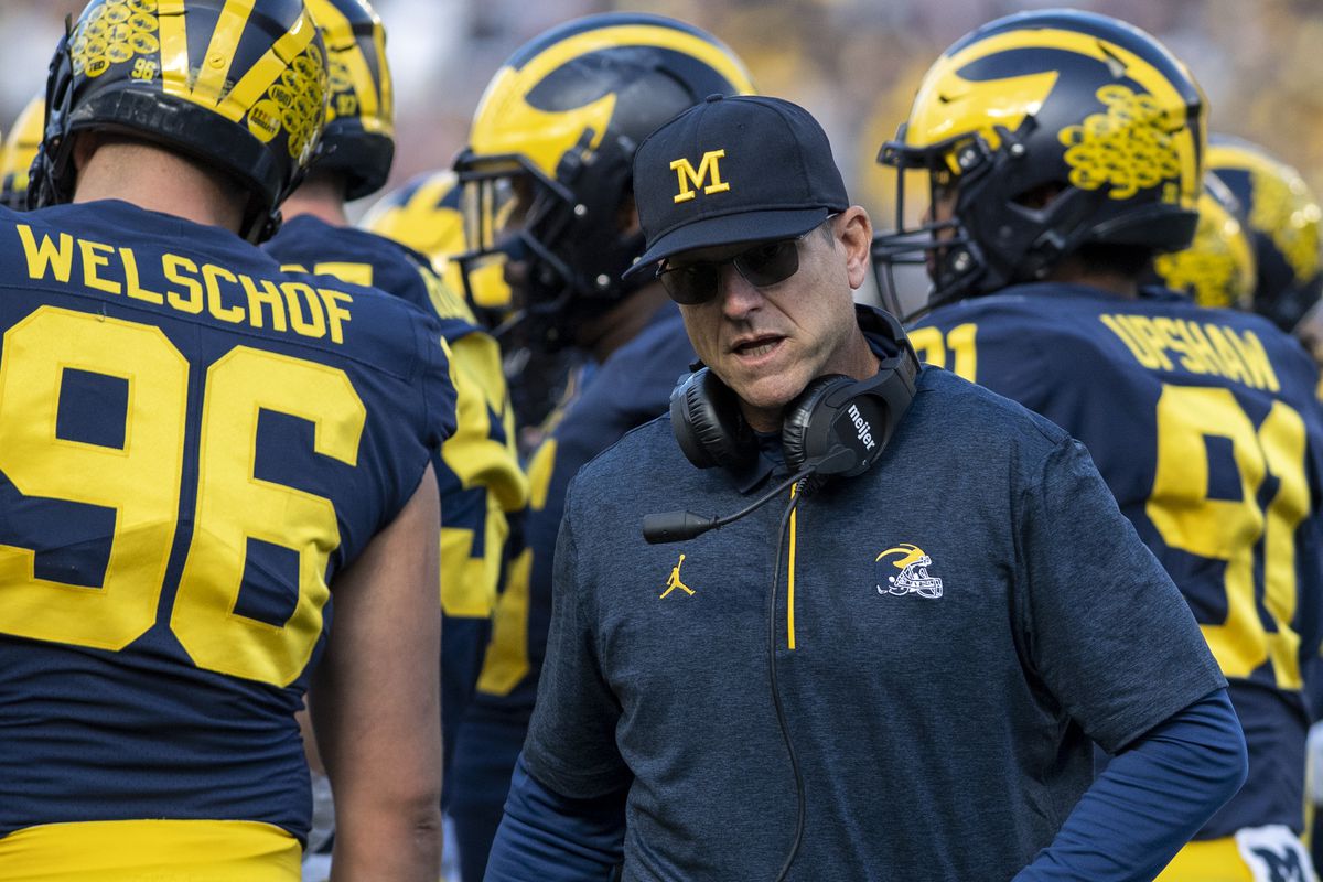 Head coach Jim Harbaugh of the Michigan Wolverines walks away from the huddle frustrated during the second quarter against the Rutgers Scarlet Knights at Michigan Stadium on September 25, 2021 in Ann Arbor, Michigan.