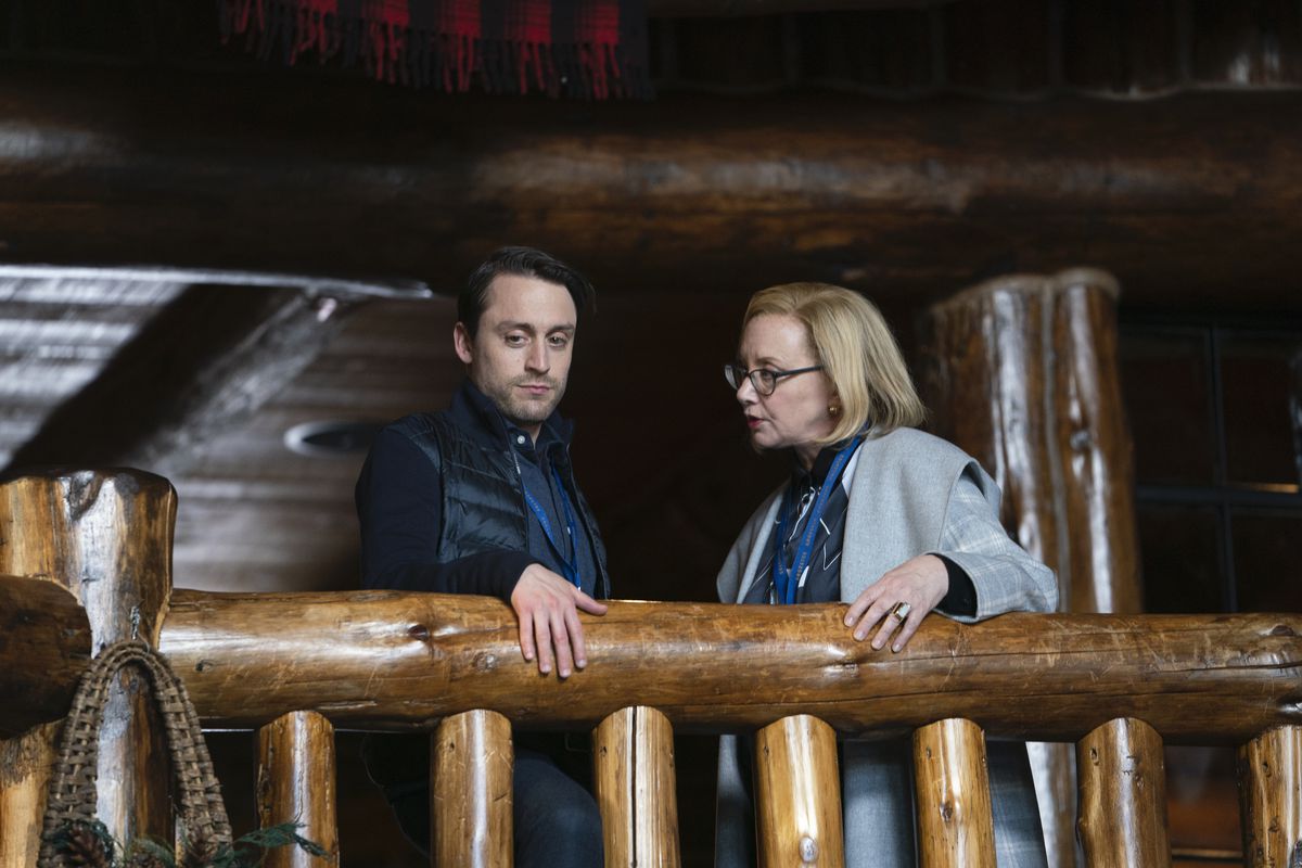 Roman (Kieran Culkin) and Gerri (J. Smith Cameron) look over a balcony in a screenshot from Succession season 2, episode 6, “Argestes”