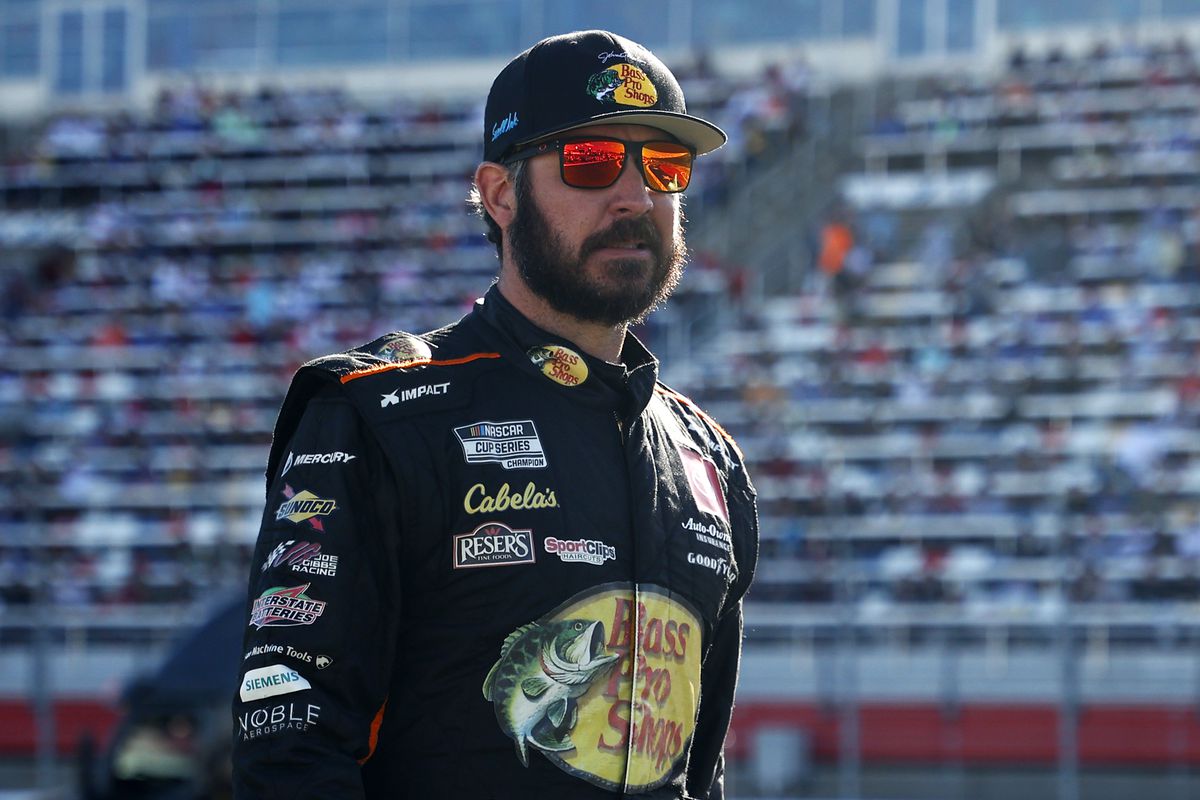 Martin Truex Jr., driver of the #19 Bass Pro Shops Red White Blue Toyota, walks the grid prior to the NASCAR Cup Series Coca-Cola 600 at Charlotte Motor Speedway on May 30, 2021 in Concord, North Carolina.