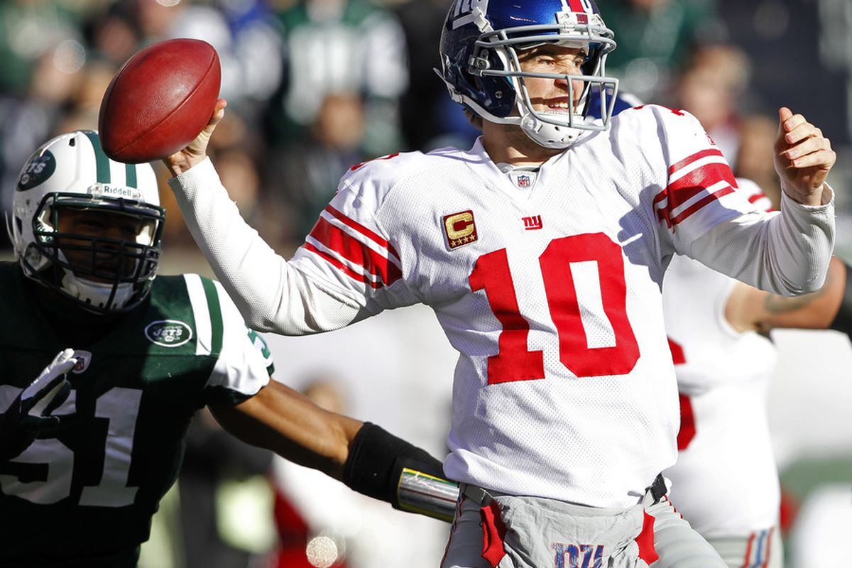 Eli Manning of the New York Giants looks to throw a pass against the New York Jets during the first quarter of a game at MetLife Stadium on December 24, 2011 in East Rutherford. New Jersey. (Photo by Rich Schultz /Getty Images)