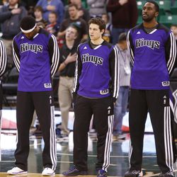 Sacramento Kings point guard Jimmer Fredette (middle) stands with the Kings during the National Anthem prior to his team playing the Jazz in Salt Lake City Saturday, Dec. 7, 2013.