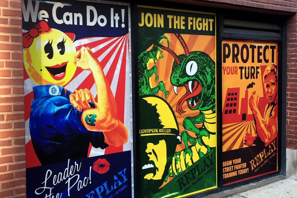 three posters on a brick wall: rosie the riveter with ms. pac-man’s head, a centipede attacking a GI, and a soldier in front of a factory
