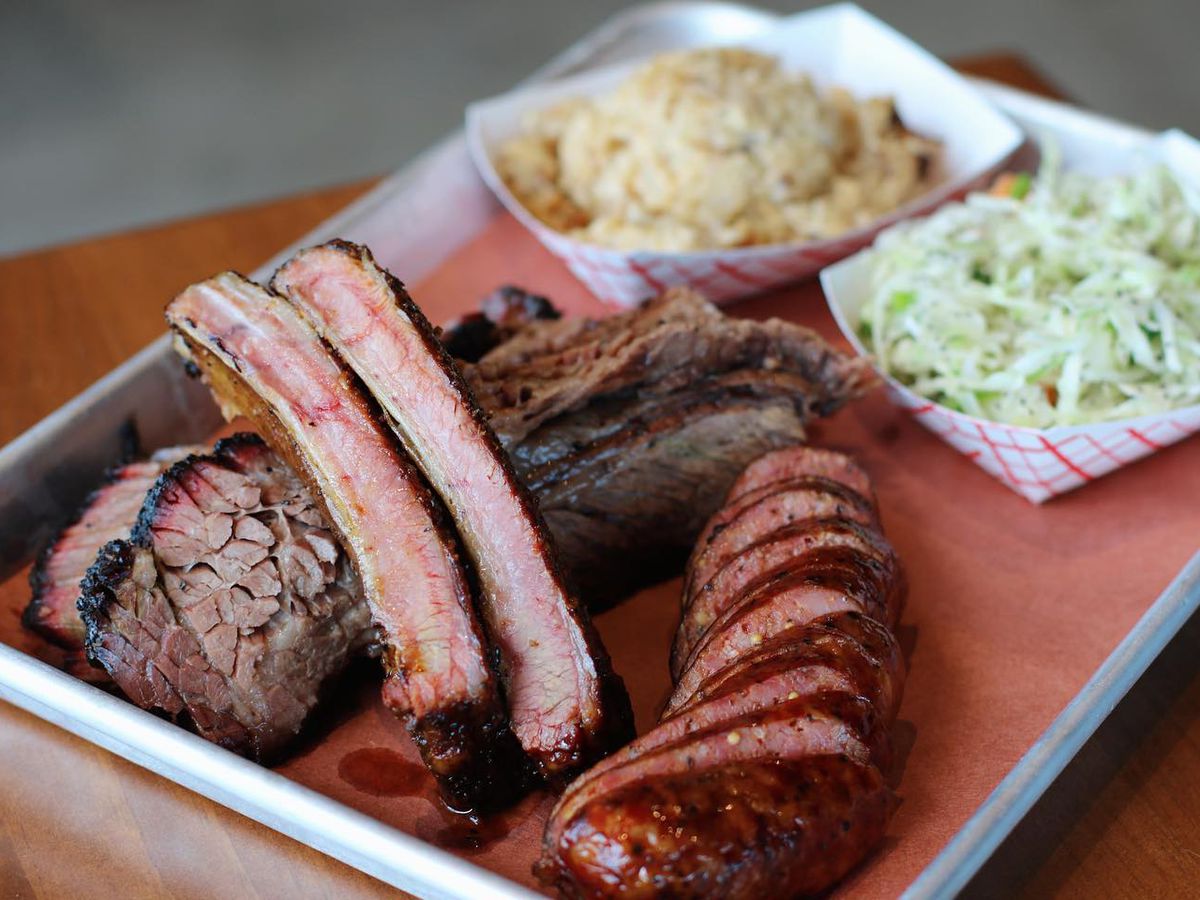 brisket, ribs and sausage on a platter with two sides