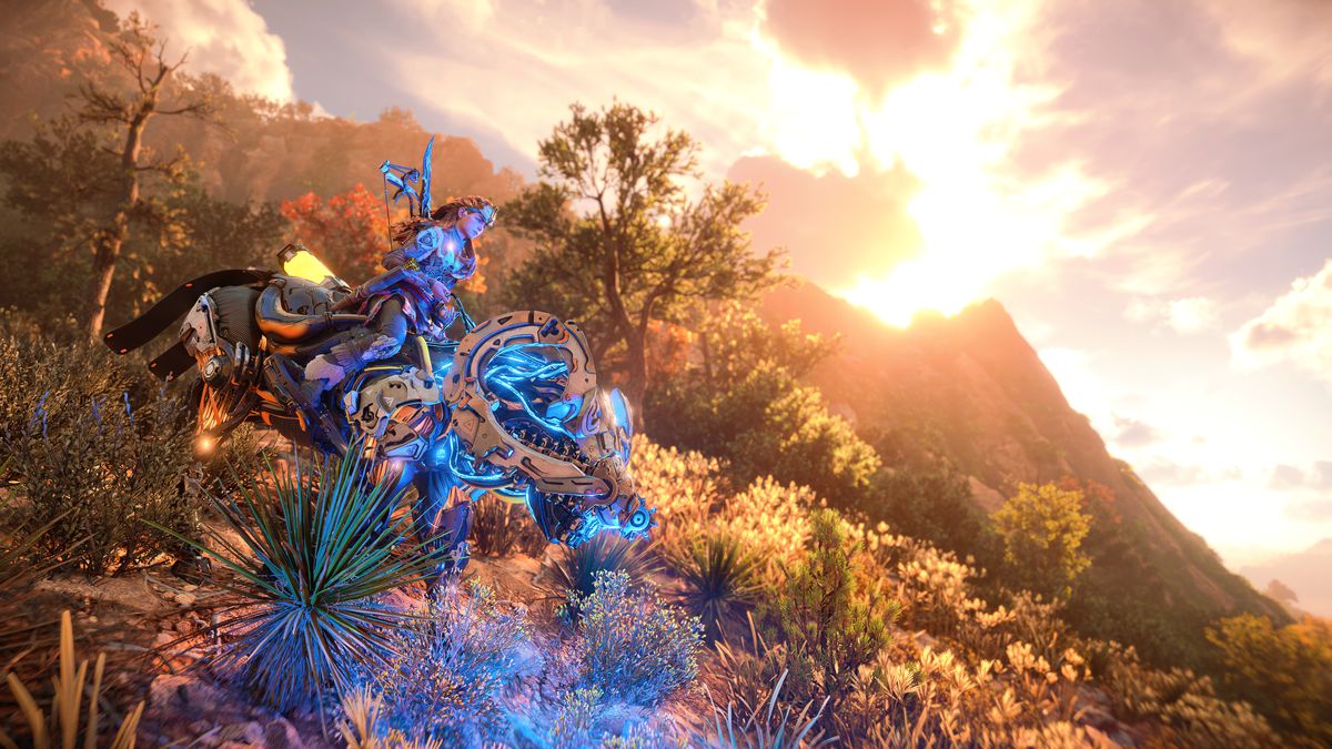 Aloy rides a Charger down a brush-covered hill in Horizon Forbidden West on PS5