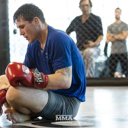 Darren Till takes a break during his workout.