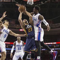 Philadelphia 76ers\' Joel Embiid, right, defends the shot attempt by Utah Jazz\'s Rudy Gobert, center, during the first half of an NBA basketball game, Monday, Nov. 7, 2016, in Philadelphia. (AP Photo/Chris Szagola)
