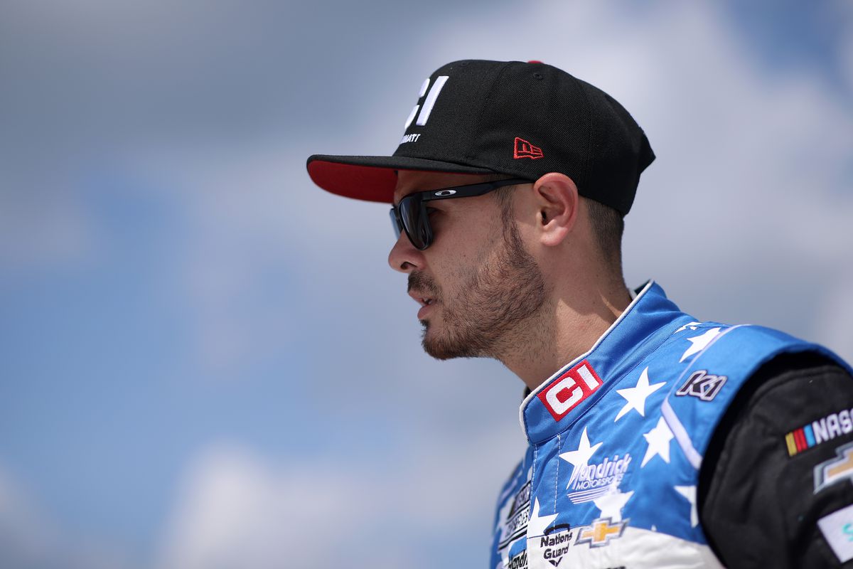 Kyle Larson, driver of the #5 Cincinnati Chevrolet, walks the grid during driver introductions prior to the NASCAR Cup Series FireKeepers Casino 400 at Michigan International Speedway on August 22, 2021 in Brooklyn, Michigan.