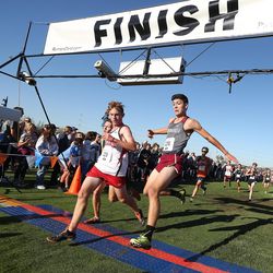 Bear River High School’s Keyjun Hale, left, watches Springville High’s Ben Price try to beat him at the finish line during the boys varsity 5K during the BYU Autumn Classic Cross Country Invitational at the East Bay Golf Course Saturday, Sept. 14, 2019 in Provo. Hale beat Price by .7 of a second.