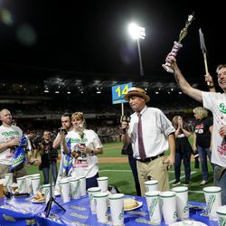 Steve Hammond, of Kirkland, Wash., celebrates his win in a Nathan's Famous qualifier hot dog-eating contest, having eaten 32 hot dogs, at Smith's Ballpark in Salt Lake City on Tuesday, July 23, 2019. The top male and female finishers in the event qualified for a seat at the 2020 Nathan’s Famous Fourth of July International Hot Dog Eating Contest in Coney Island, New York.