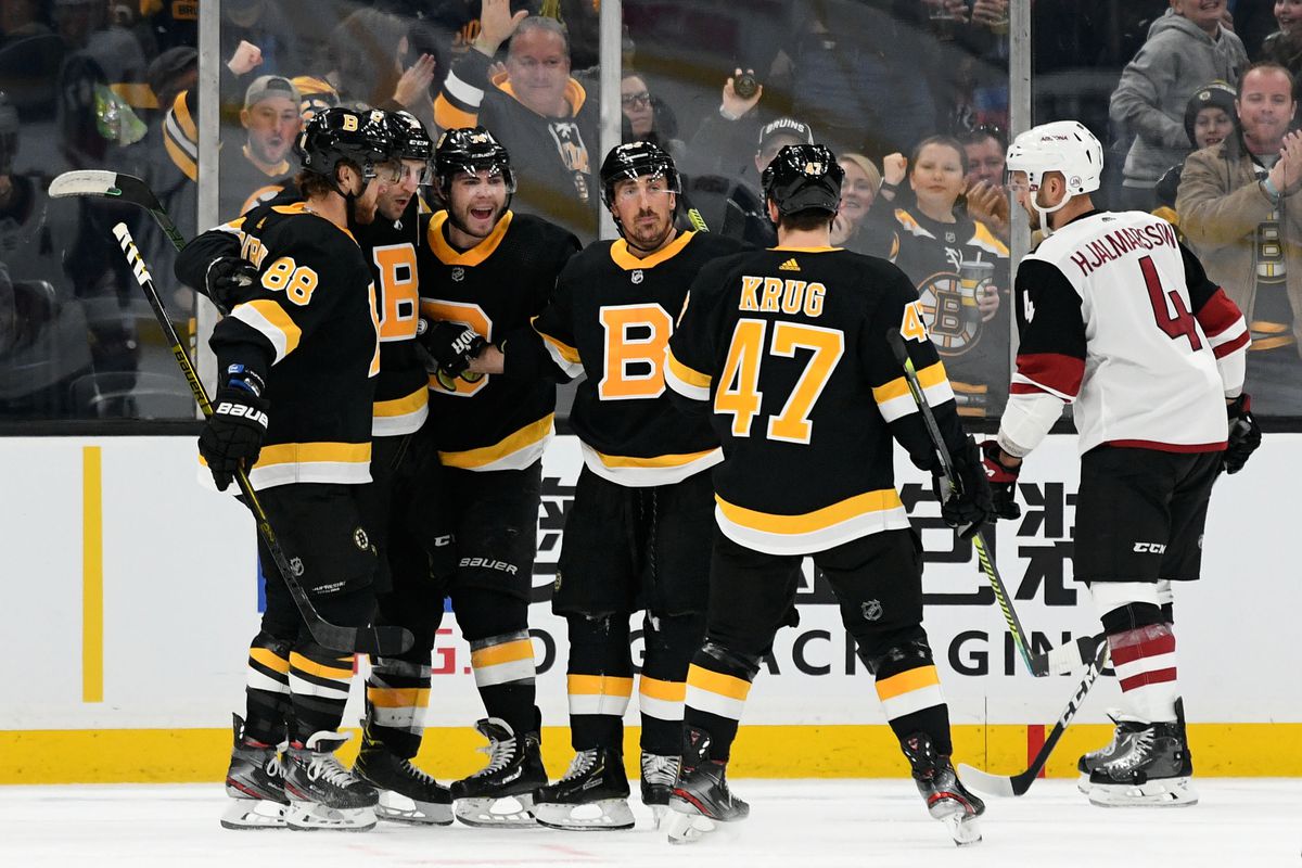 Boston Bruins center Patrice Bergeron celebrates with right wing David Pastrnak, left wing Brad Marchand, left wing Jake DeBrusk, and defenseman Torey Krug after scoring against the Arizona Coyotes during the second period at the TD Garden.