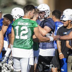 New and returning players greet each other during the BYU Cougars' first practice of the season in Provo on Thursday, July 27, 2017.