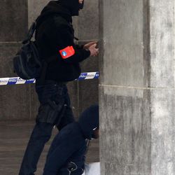 A Belgian police officer detains a man at the Gare du Midi train station in Brussels, Tuesday, March 22, 2016. Explosions, at least one likely caused by a suicide bomber, rocked the Brussels airport and its subway system Tuesday, prompting a lockdown of the Belgian capital and heightened security across Europe. 