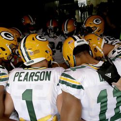 Green Bay Packers players, including former BYU wide receiver Colby Pearson (1), huddle up prior to an NFL preseason football game against the Denver Broncos, Saturday, Aug. 26, 2017, in Denver.