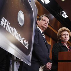 FILE - In this Jan. 28, 2016, file photo, Sen. Gary Peters, D-Mich., left, and Sen. Debbie Stabenow, D-Mich., listen to a question as they discuss proposed legislation to help Flint, Mich. with their current water crisis during a news conference on Capitol Hill in Washington. It’s been two years since problems began with the drinking water in Flint, Michigan, and nearly six months since officials declared a public health emergency. Yet a bipartisan congressional effort to aid the predominantly African-American city is idling in the Senate. 