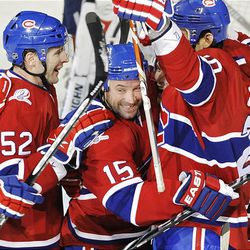 Montreal Canadiens' Glen Metropolit, center, celebrates with teammates Mathieu Darche, left, and Ryan O'Byrne after scoring against the Washington Capitals' during second-period action.